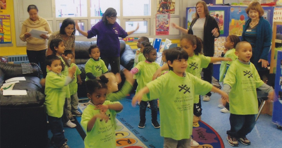 Children and teachers playing in a classroom