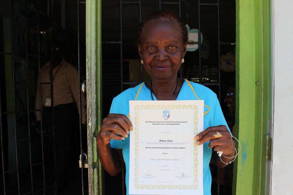 The Principal of an early childhood education centre holding her certificate of accomplishment in Early Childhood Education