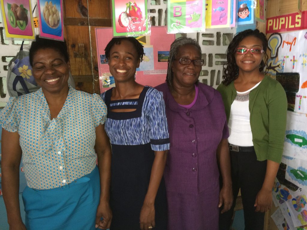 Four early childhood teachers smiling in a classroom setting