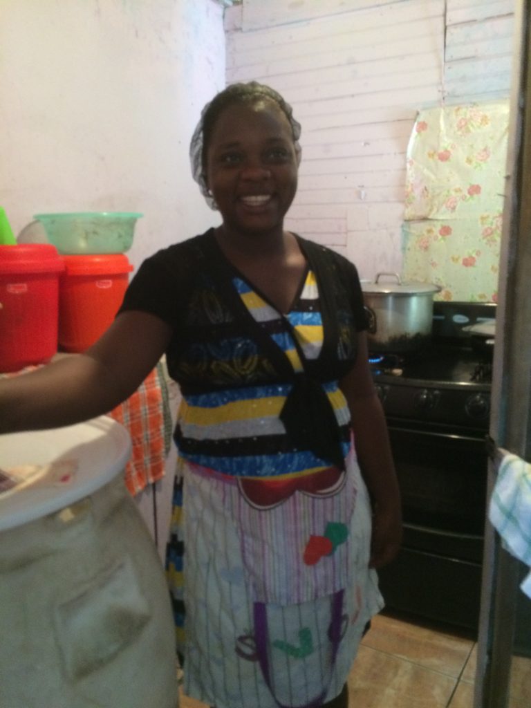 A teacher smiling in the kitchen